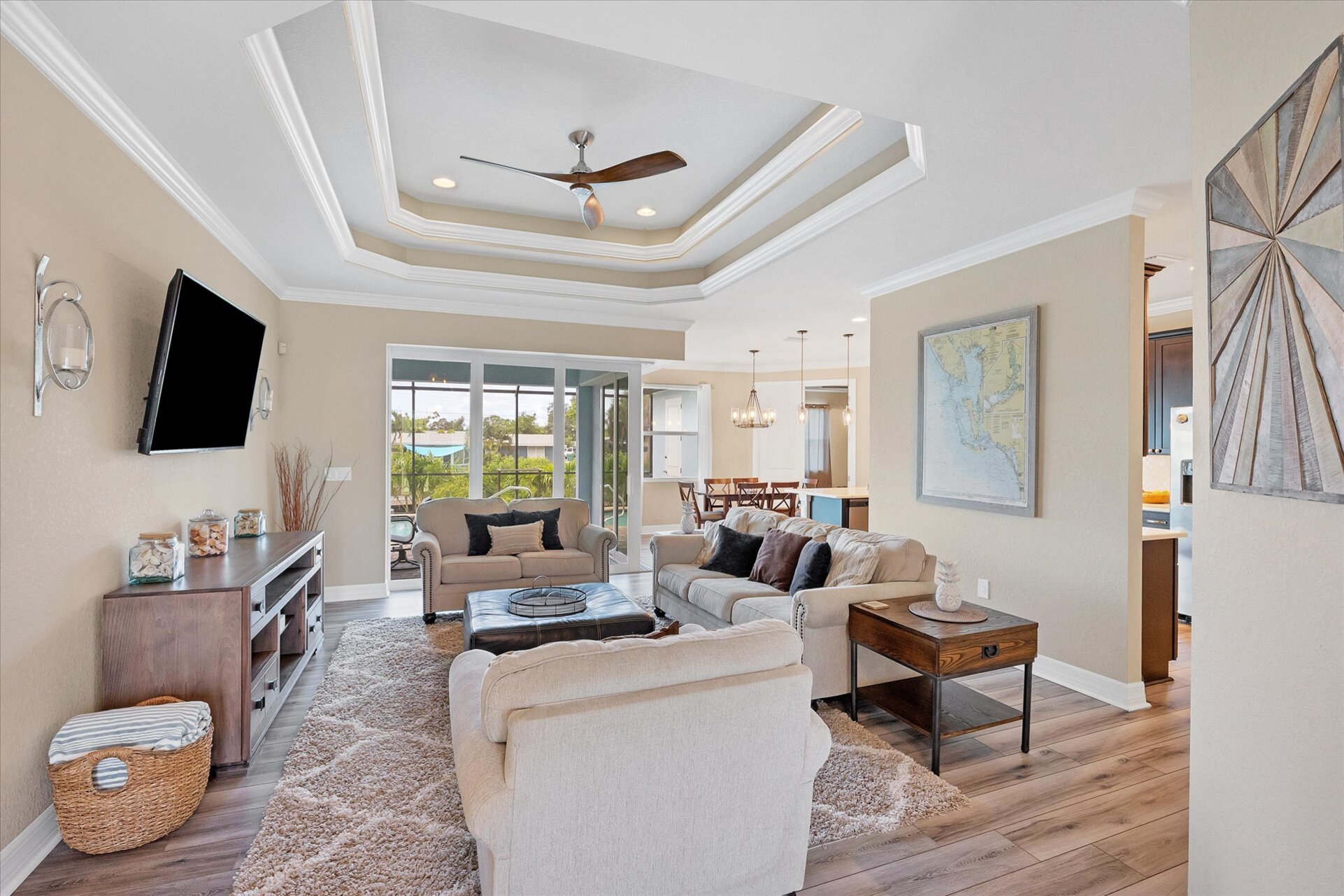 Large living room overlooking pool. Living room features comfy, ample seating and large 65-inch Smart TV