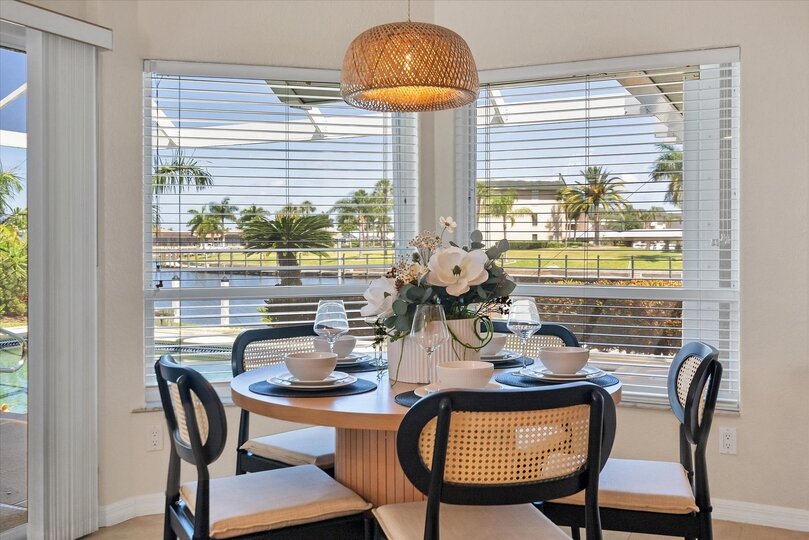 Dining table seats 5 and overlooks the private pool & canal