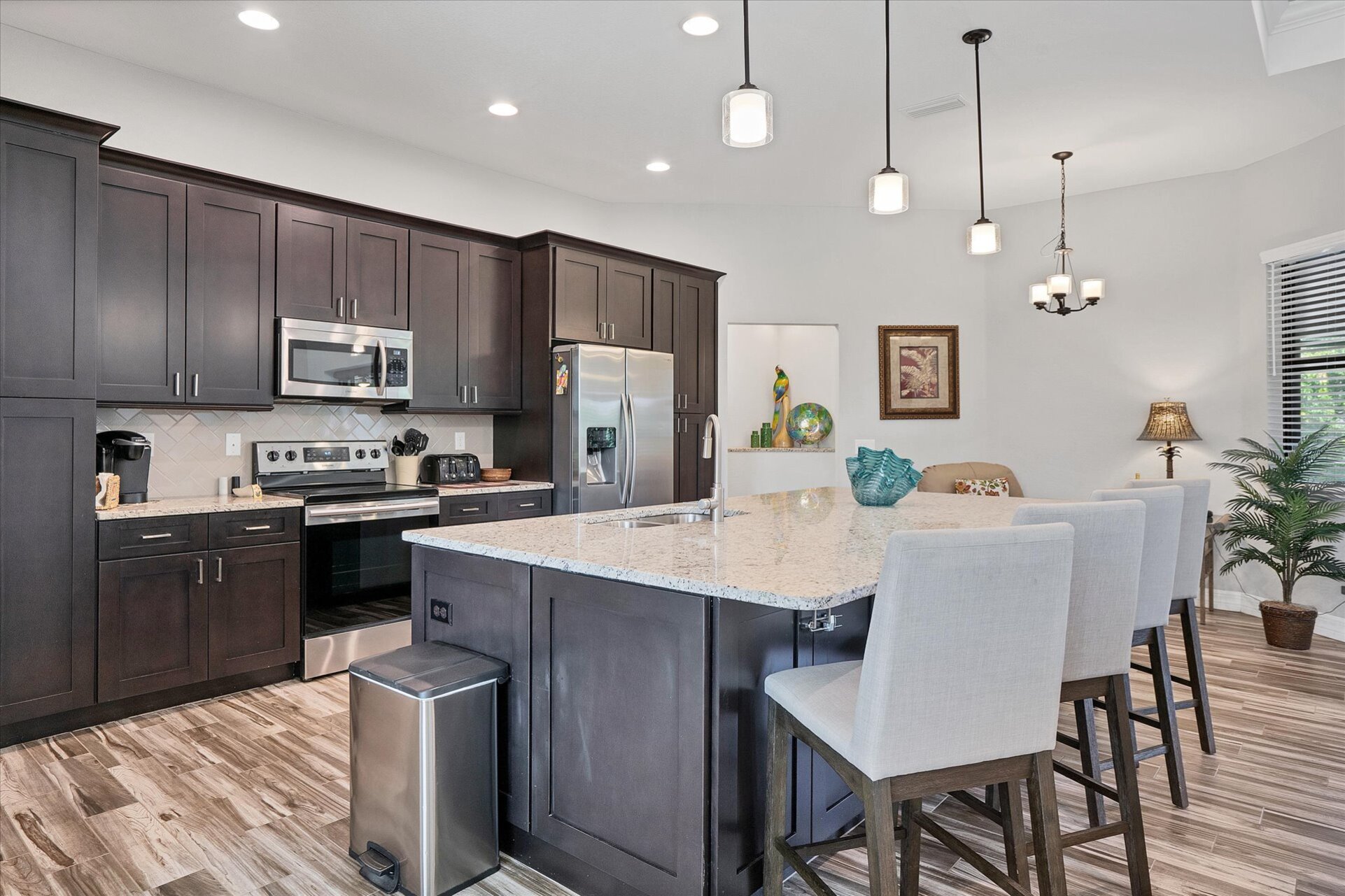 Gorgeous, fully-equipped kitchen featuring stainless steel appliances, and huge kitchen island that seats 4