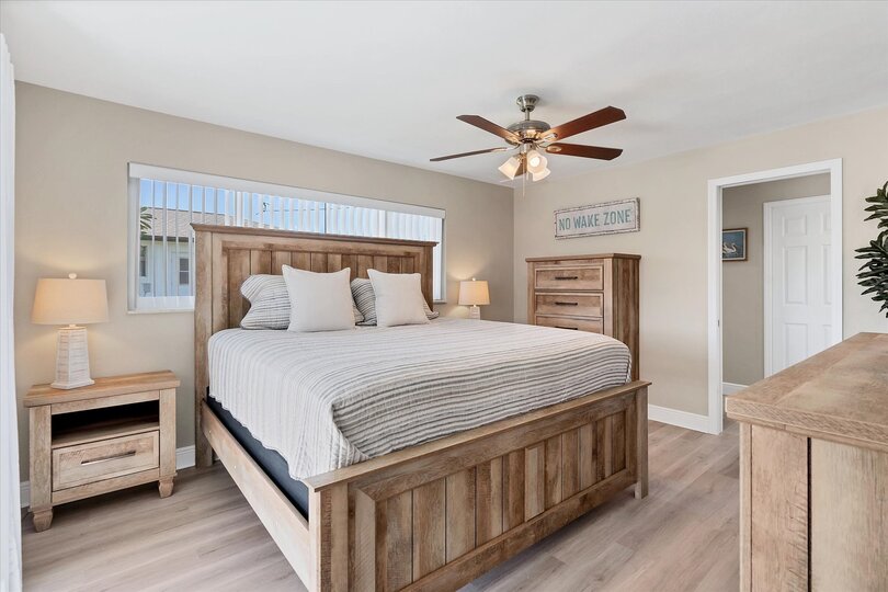 Primary bedroom with king bed, attached bathroom, and 50-inch Smart TV