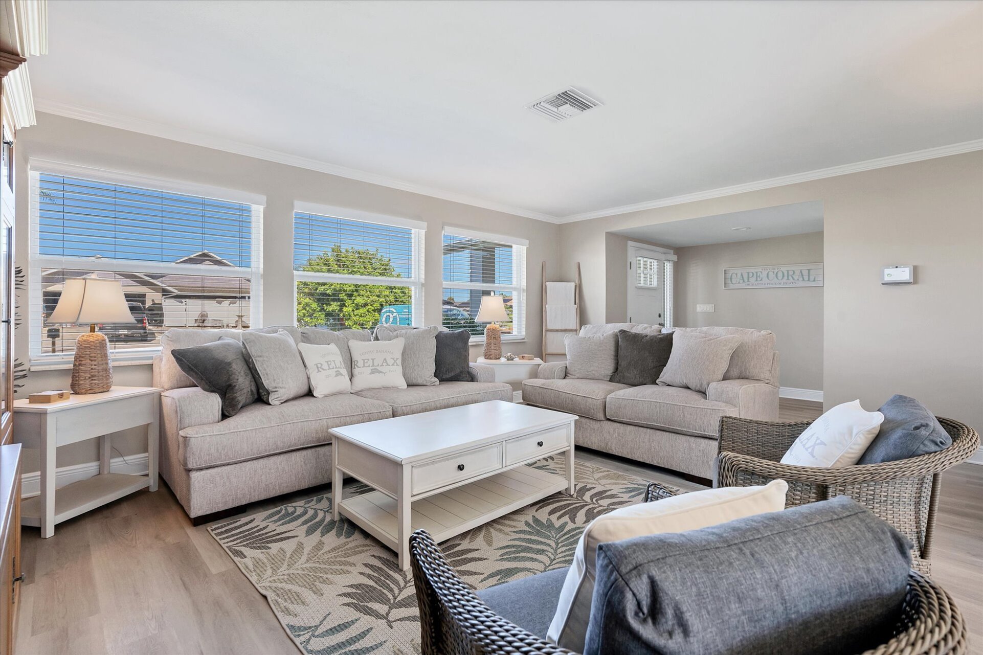 Bright, open living room with lots of comfy seating and 65-inch Smart TV
