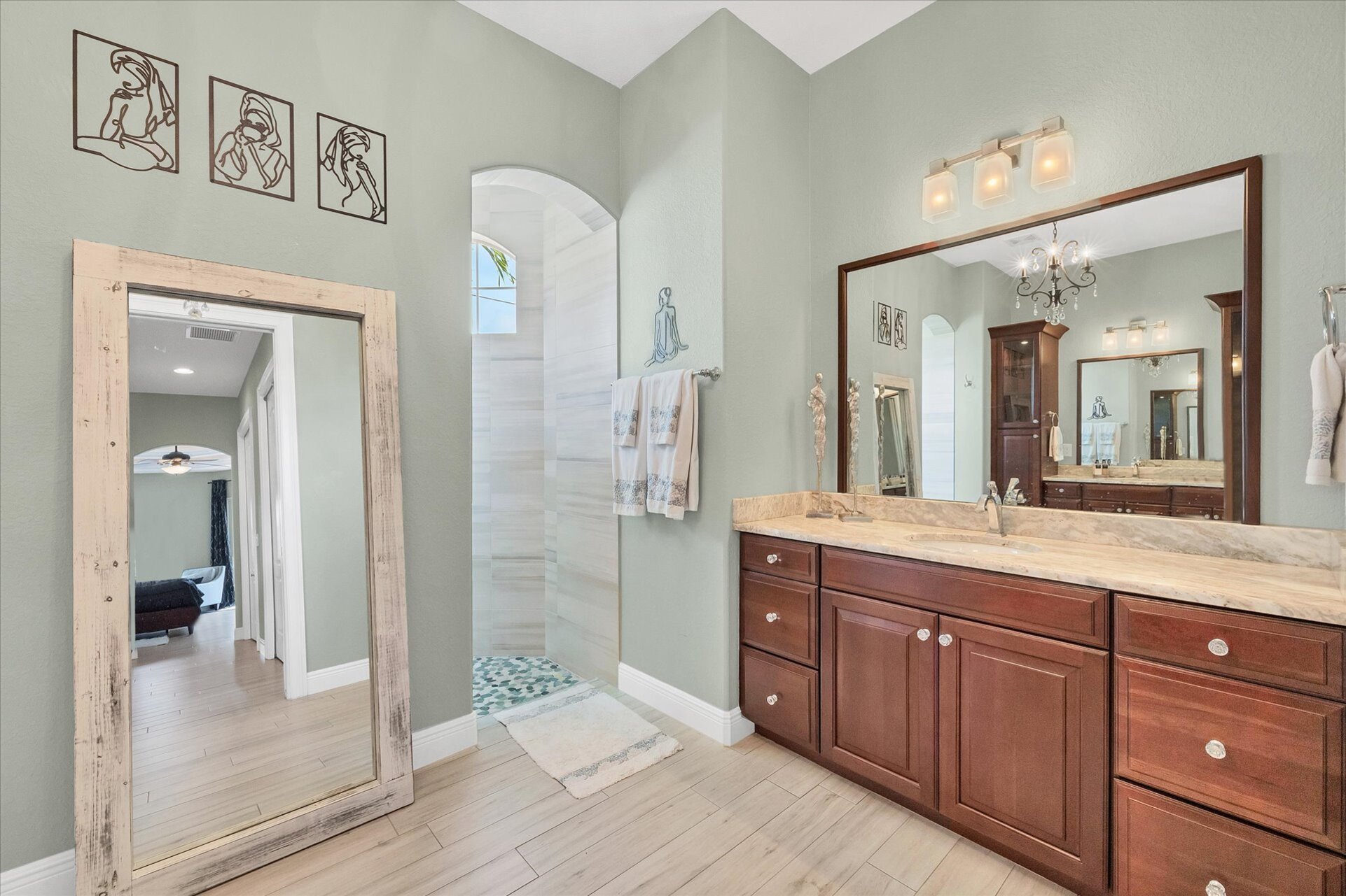Beautiful primary en suite with large walk-in shower and double vanities