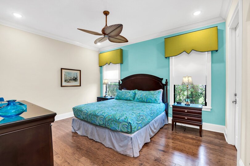 Enjoy this colorful second master bedroom with a King size bed