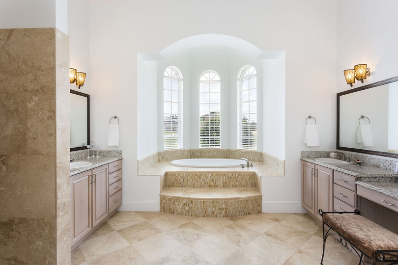 Elegant ensuite master bathroom with personal vanity areas