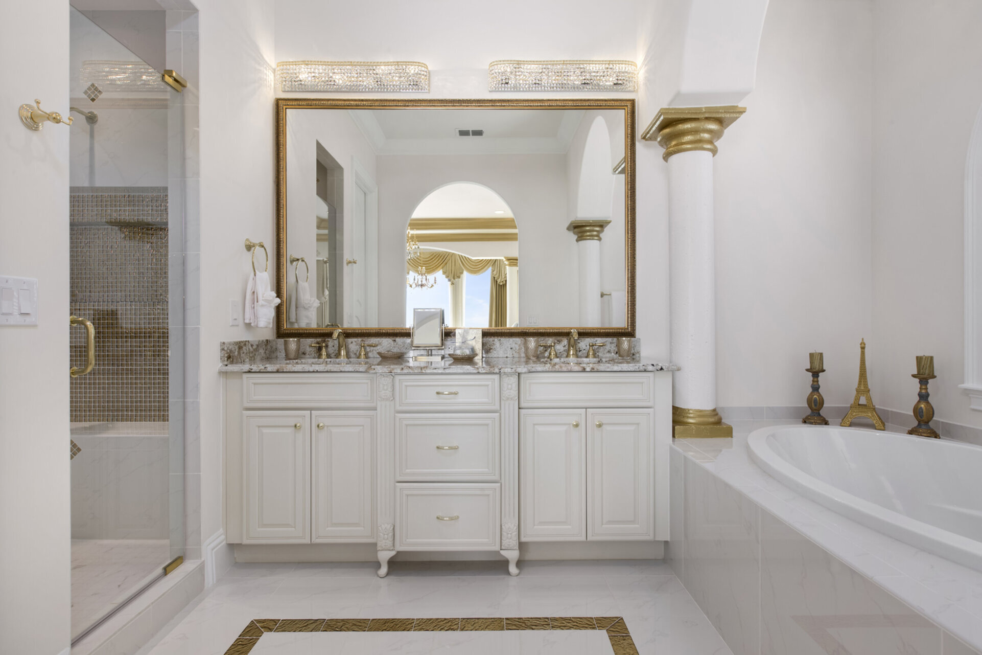 The en-suite bathroom is elegantly appointed and features both a soaking tub and glass shower