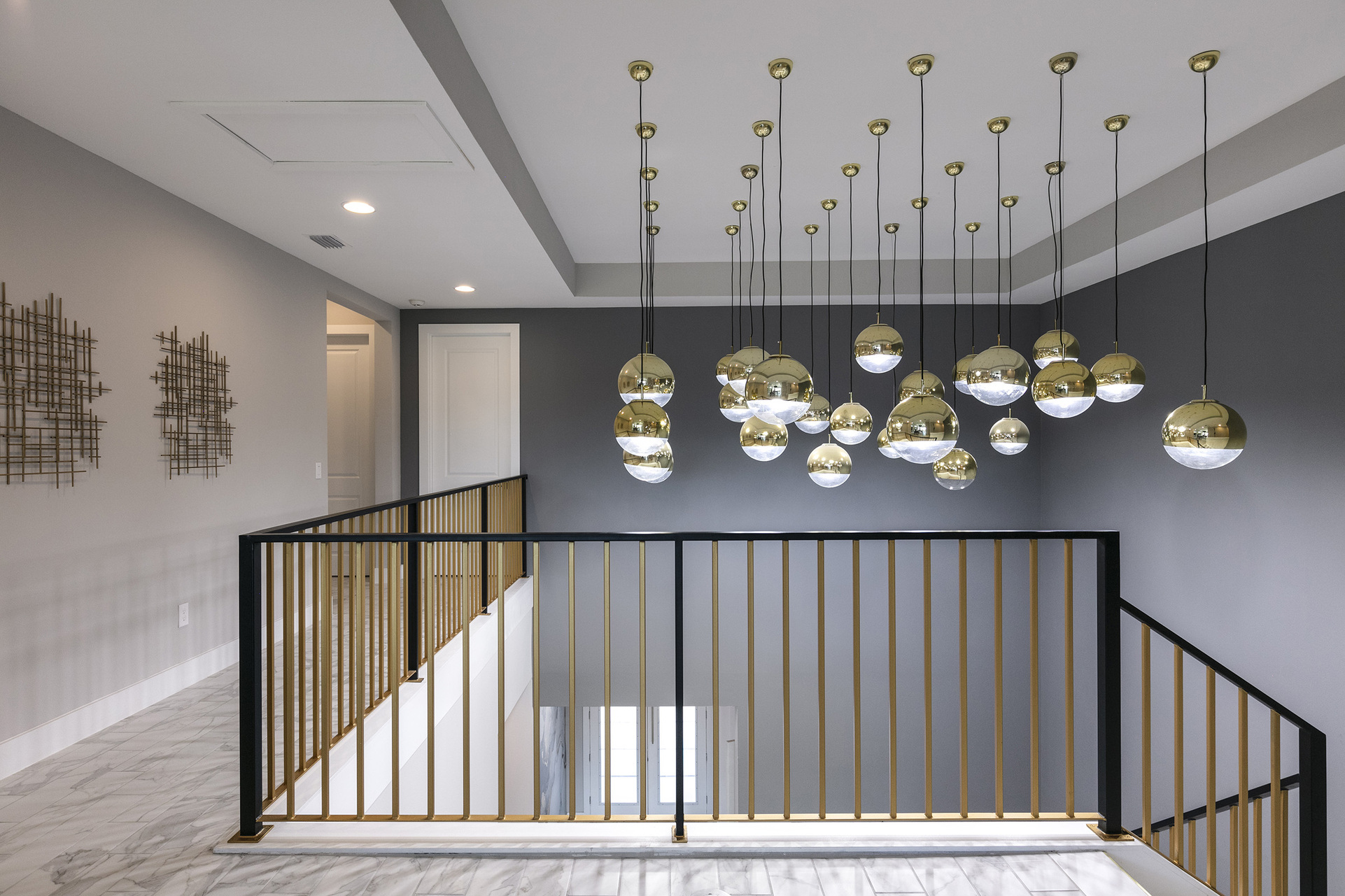 Gaze in awe at the custom light fixtures over the staircase