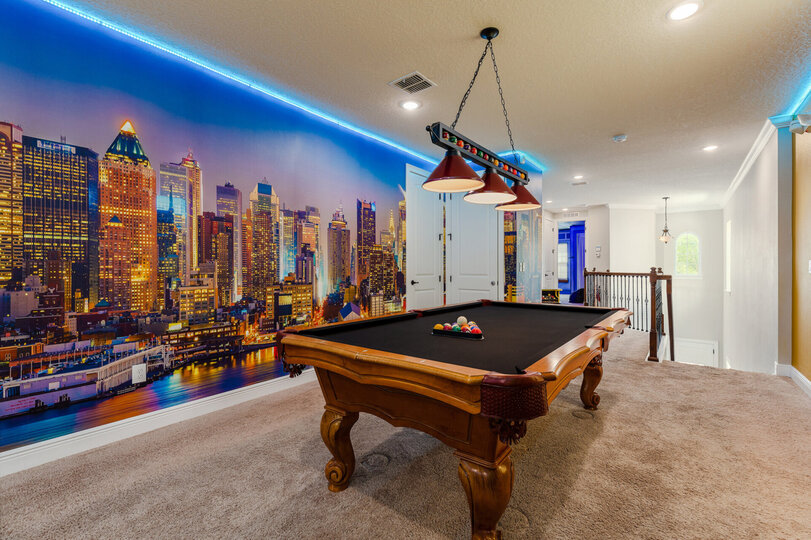 Admire the 30-ft NYC sunset skyline  during a game of pool