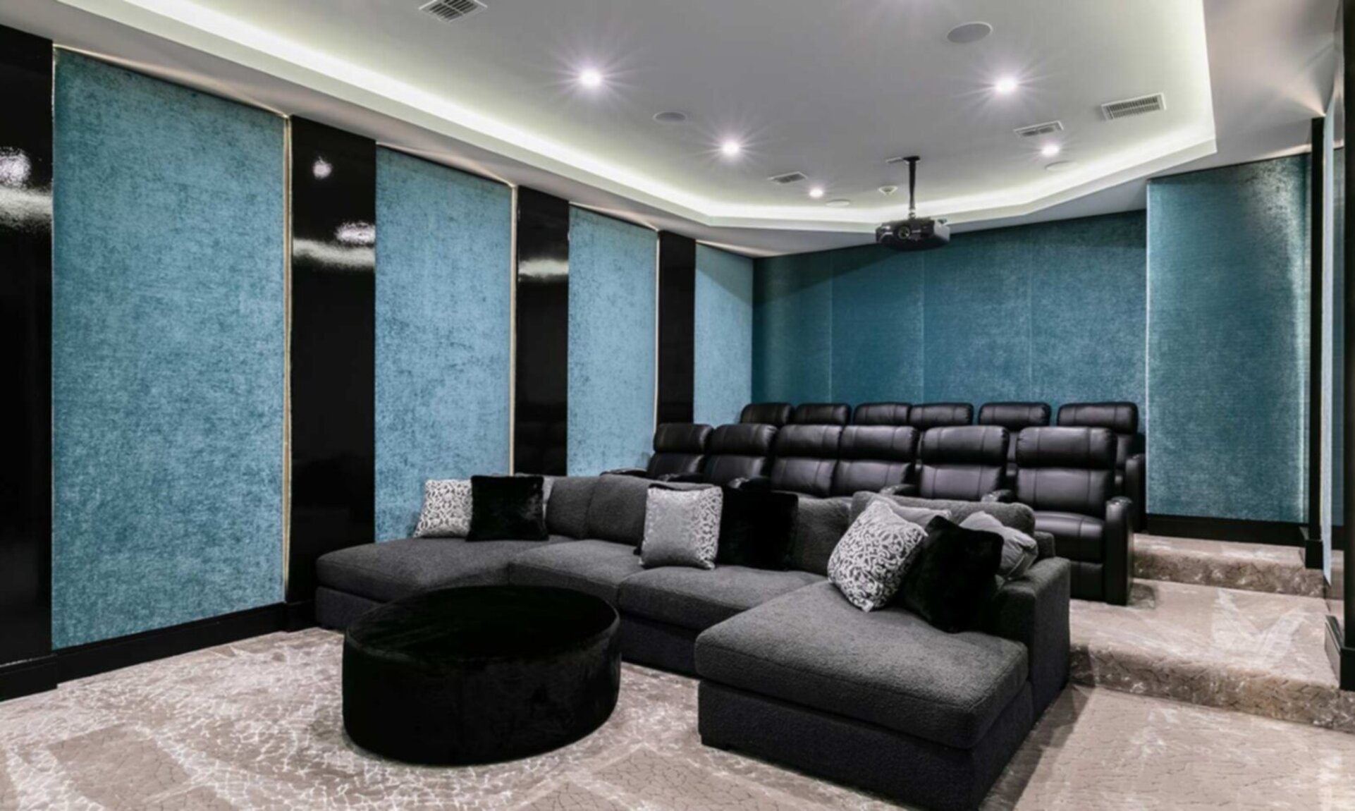 Theatre with 12 Black Leather electric reclining seats and oversized deep lush fabric sectional