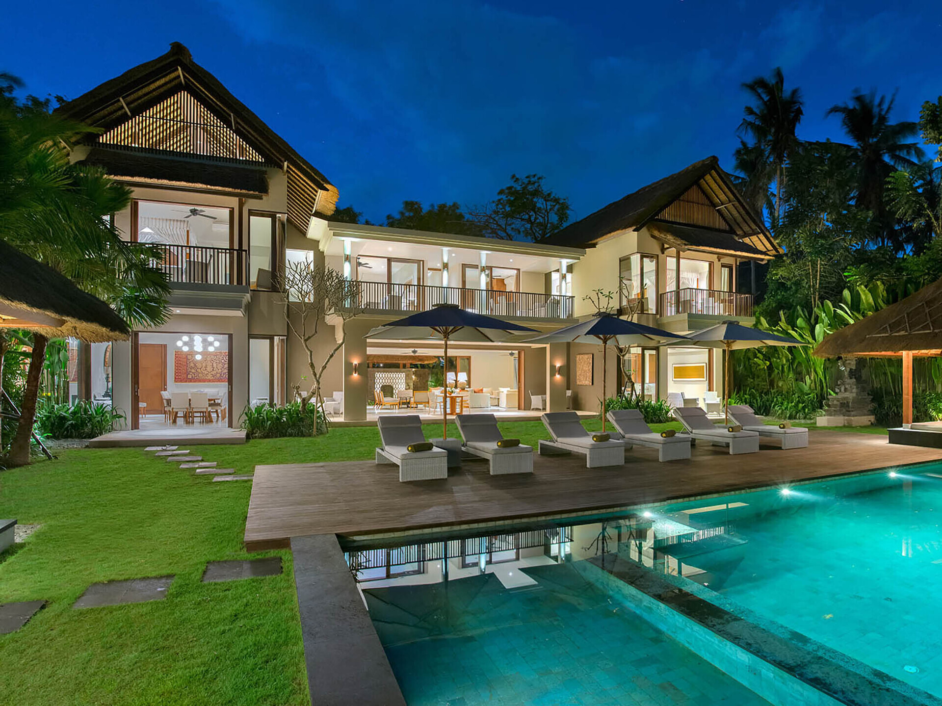 The villa lit up at night ota