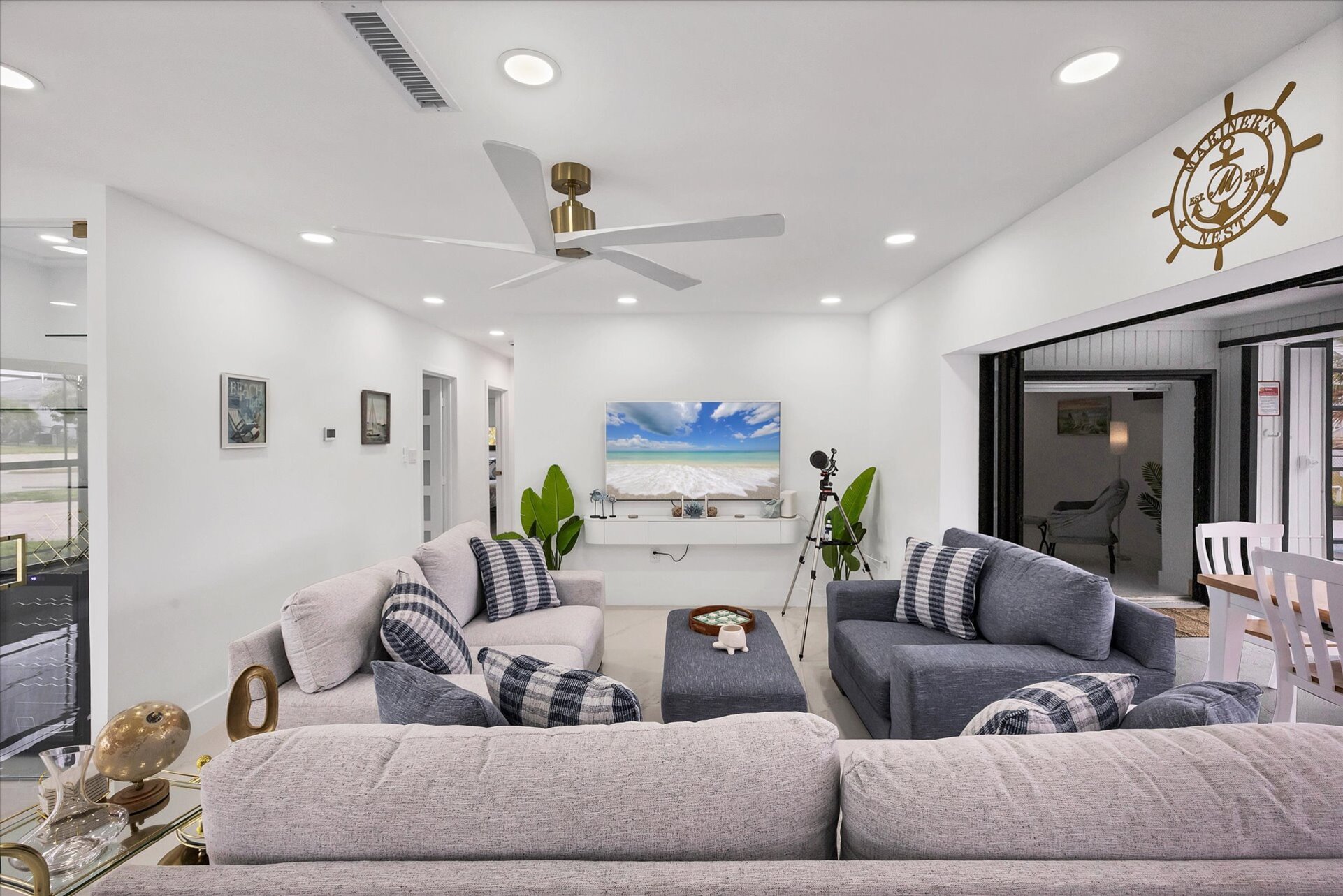 Living room overlooking the pool & canal. Living features ample & comfy seating, and 65-inch Smart TV