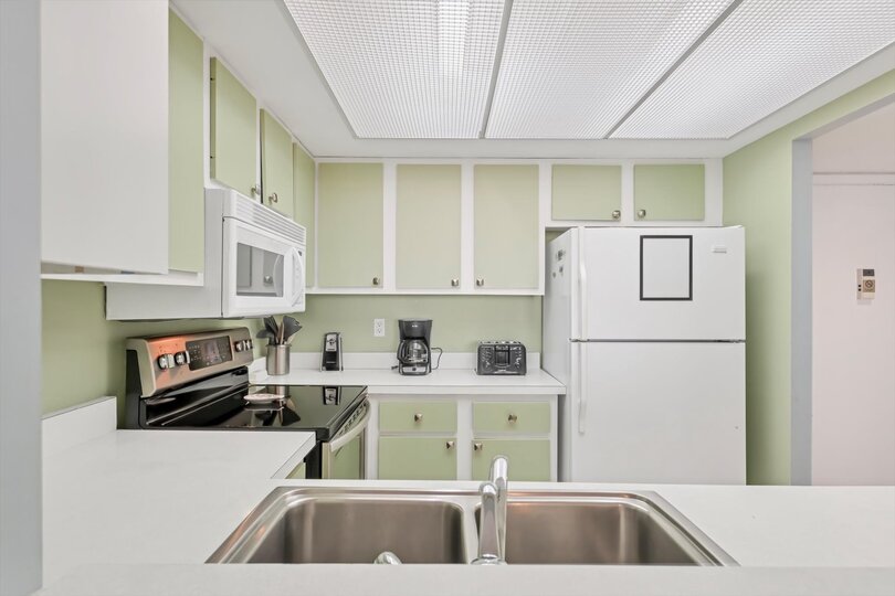 Fully-equipped kitchen overlooking living room/dining room
