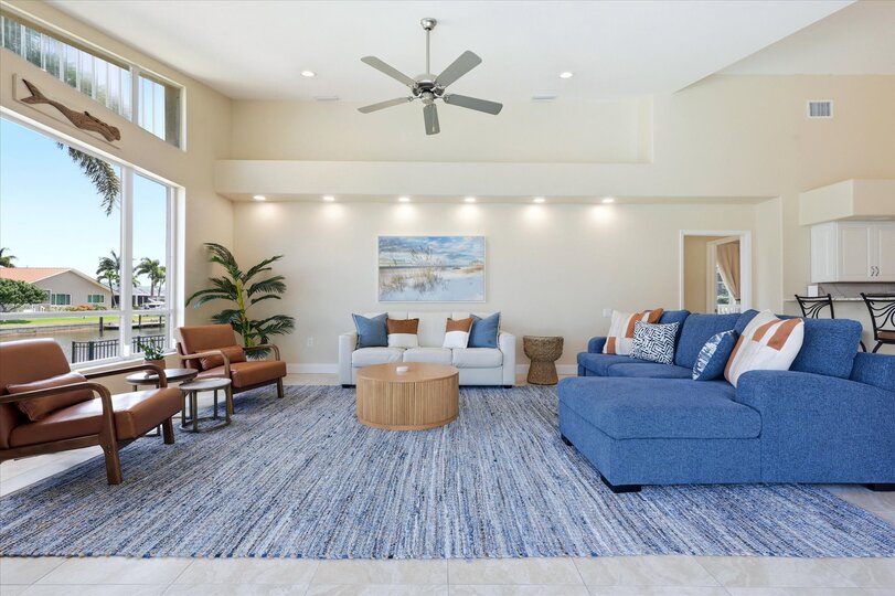 Living room overlooking the pool with lots of comfortable seating and fantastic waterviews