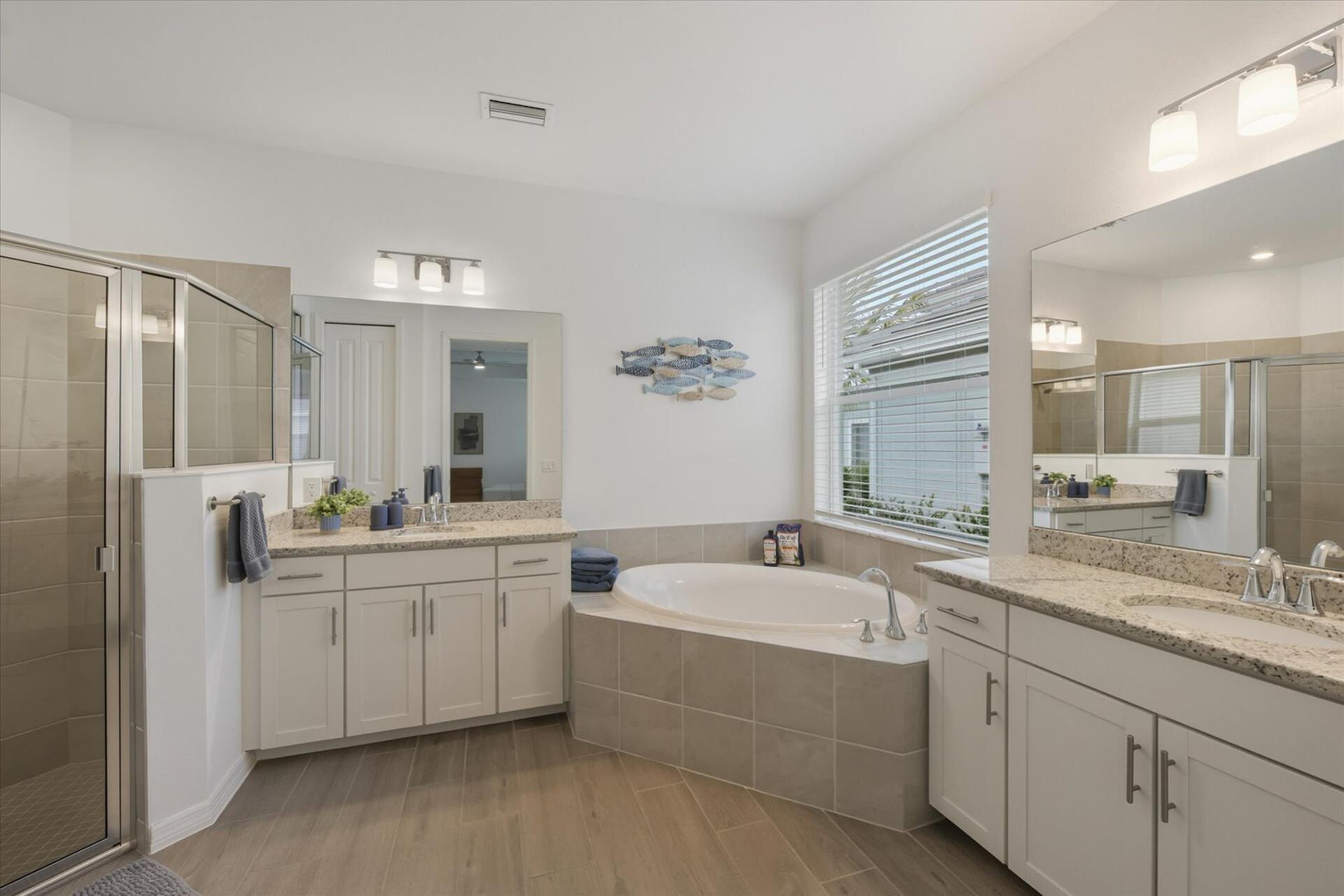 Primary attached bathroom with walk-in shower and garden tub