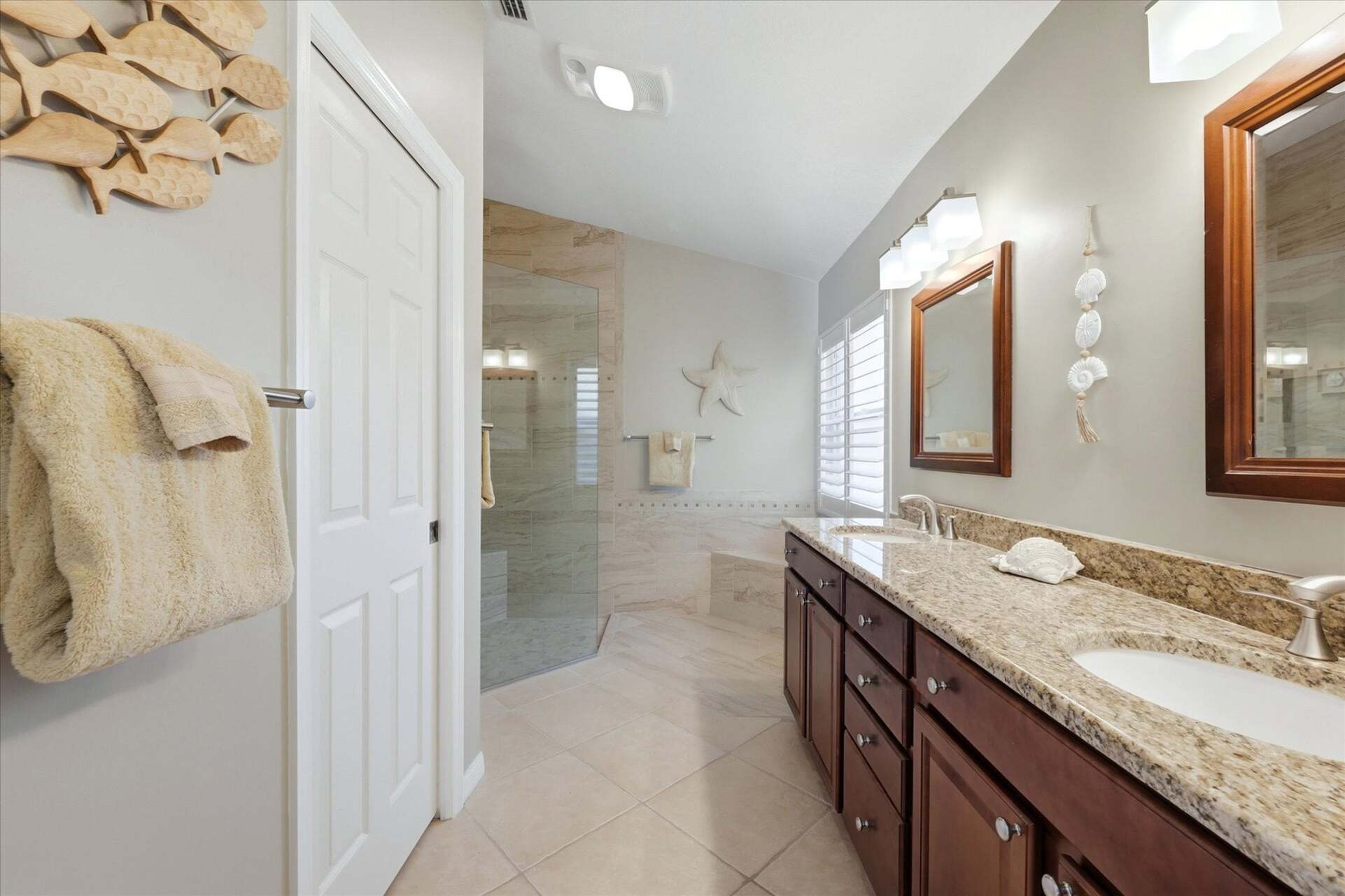 Attached bathroom with large walk-in shower and double vanities