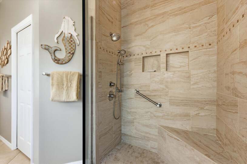 Attached bathroom with large walk-in shower and double vanities