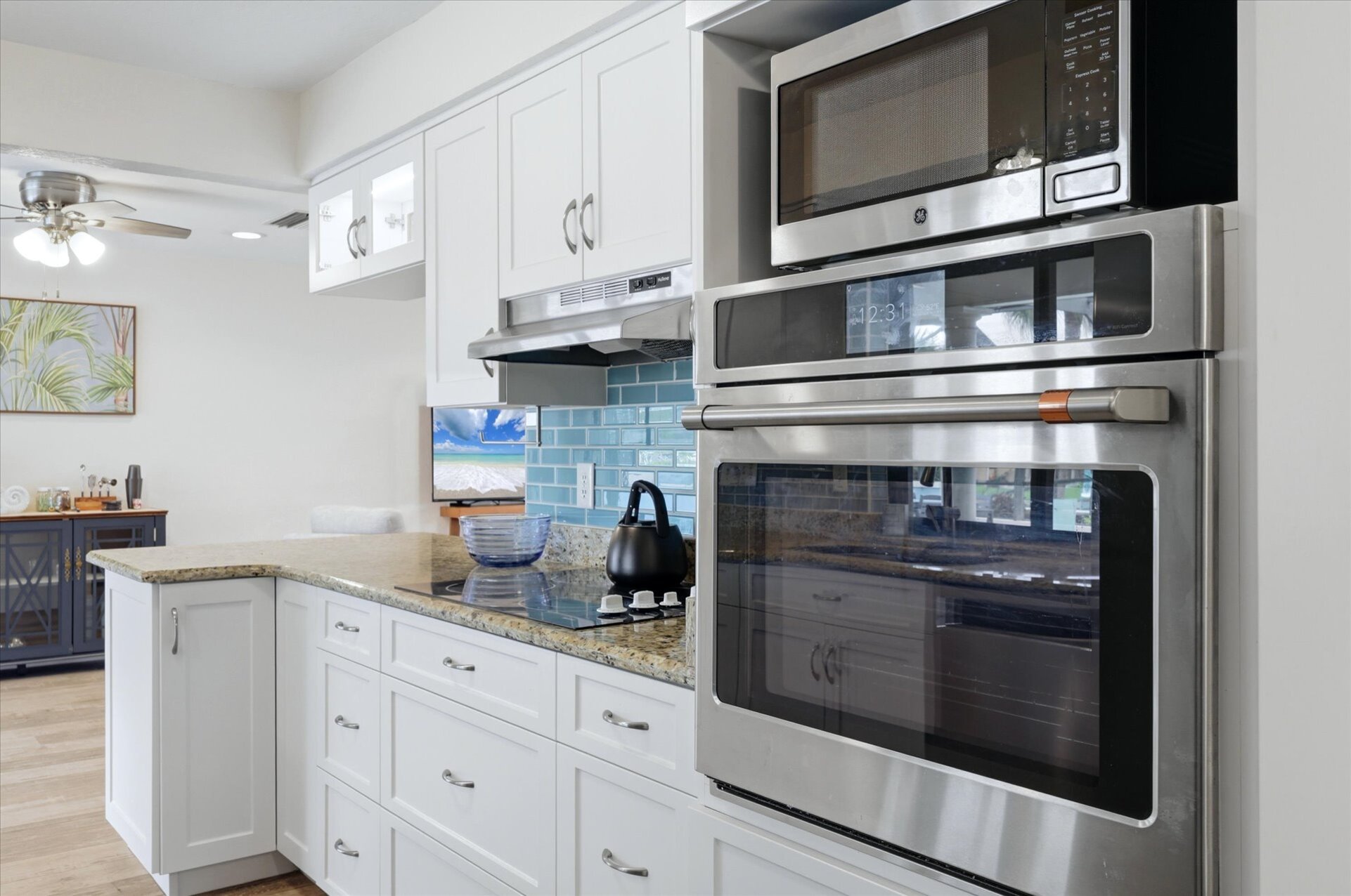Bright, fully-equipped kitchen overlooking the pool and canal