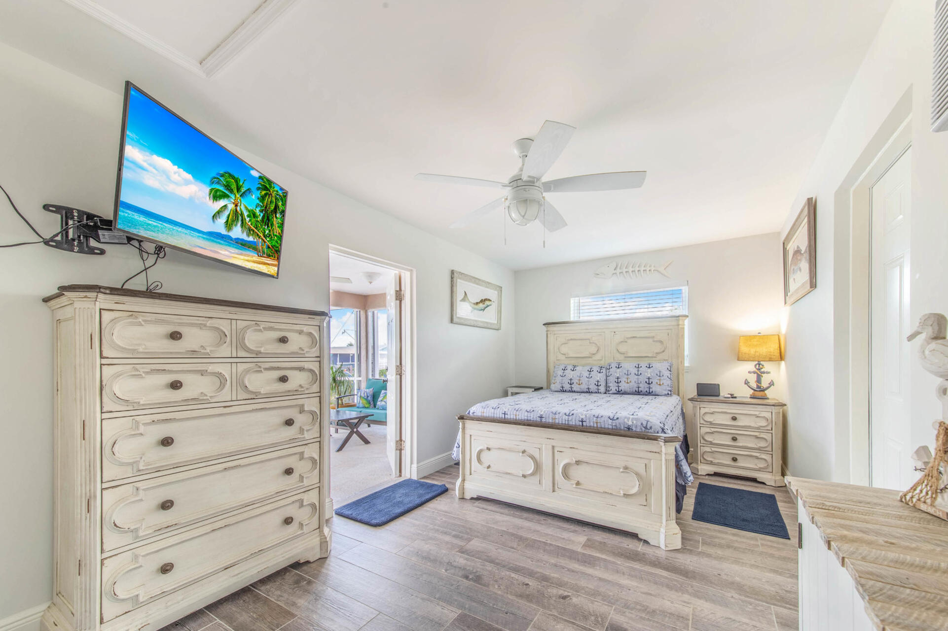 Guest bedroom 3 (off of garage) with full-size bed, attached bathroom, lanai access, 43-inch Smart TV, and private entry