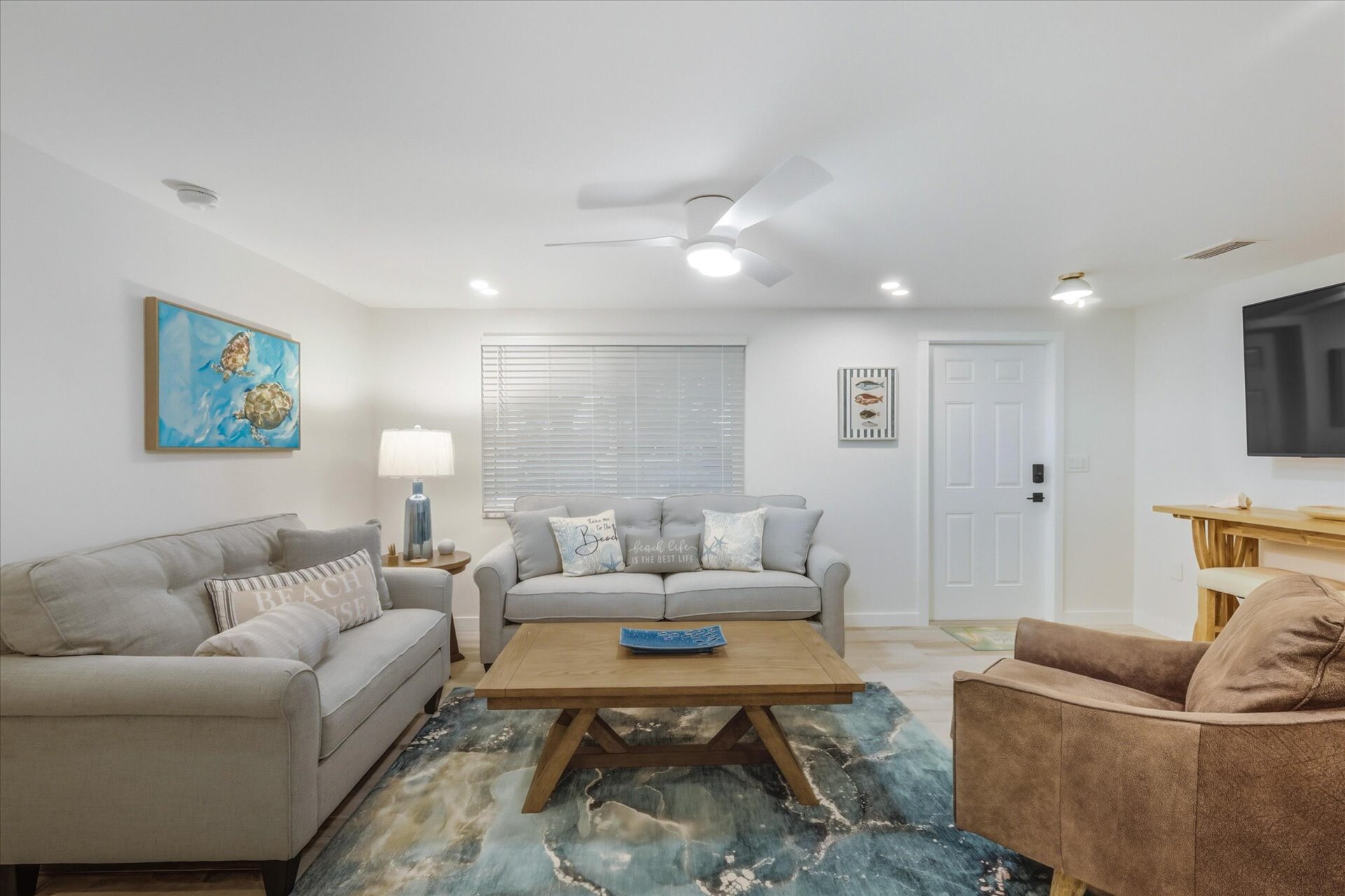Living room featuring lots of comfy seating and 65-inch Smart TV