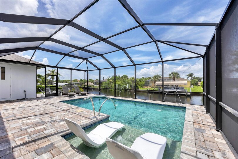 Fantastic outdoor living space overlooking the sparkling pool and canal beyond. Pool size: 24'x12'x6'