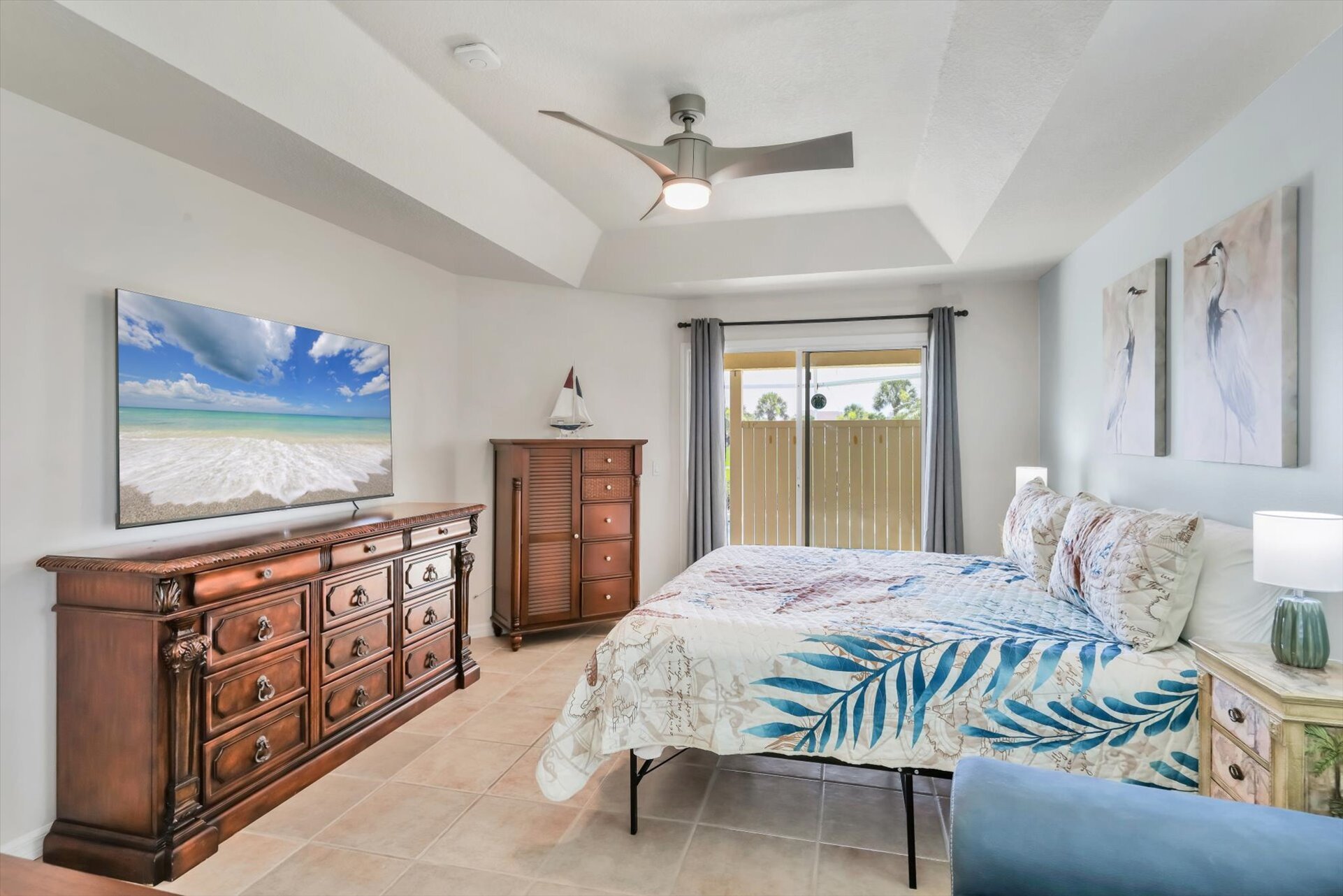 Primary bedroom with king bed, lanai access, ensuite, and 65" Smart TV