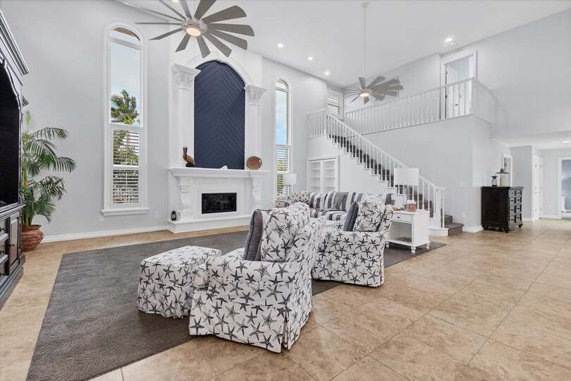 Large, open living space with ample seating, fireplace and 70-inch Smart TV