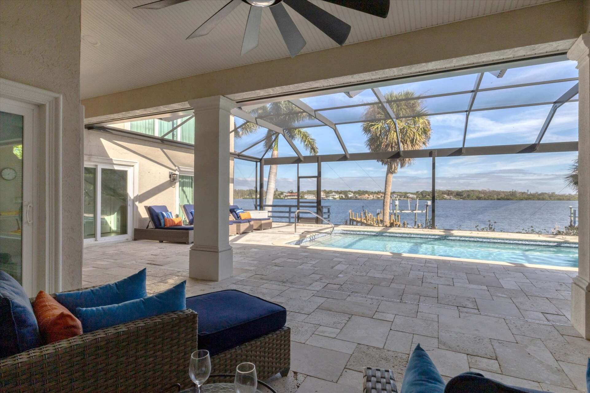 Large lanai overlooking the sparkling pool and Lemon Bay