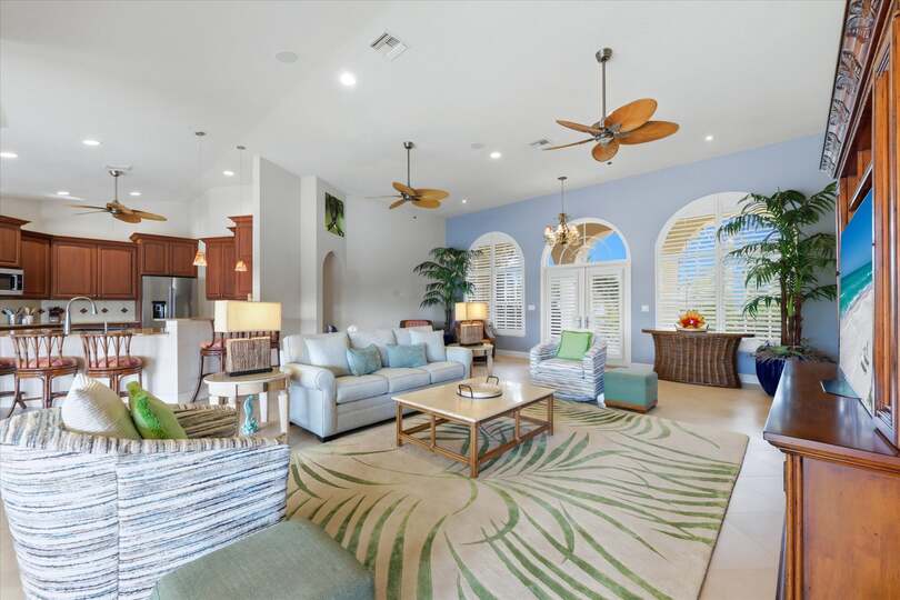 Large open living space overlooking the pool & canal beyond. Living room features lots of seating and 65-inch Smart TV