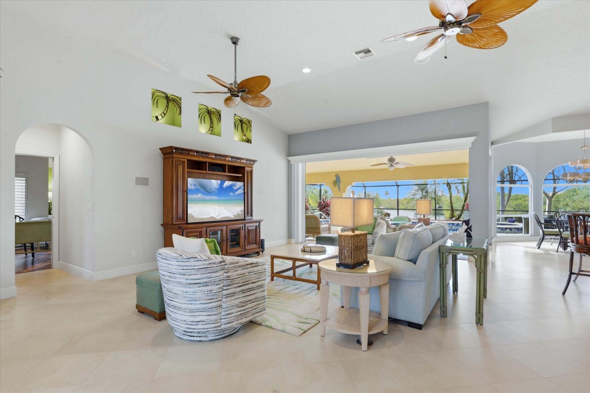 Large open living space overlooking the pool & canal beyond. Living room features lots of seating and 65-inch Smart TV