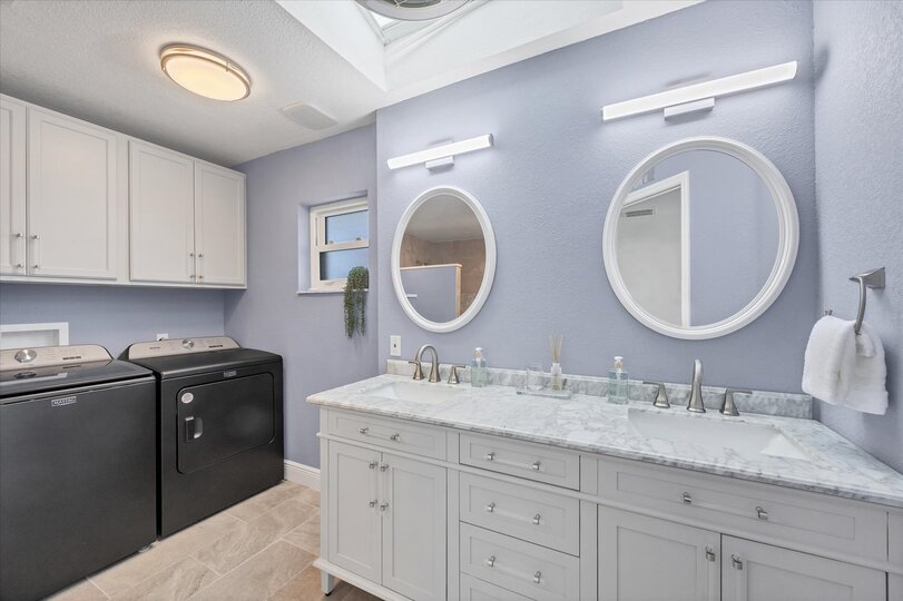 Primary attached bathroom with walk-in shower and double vanities