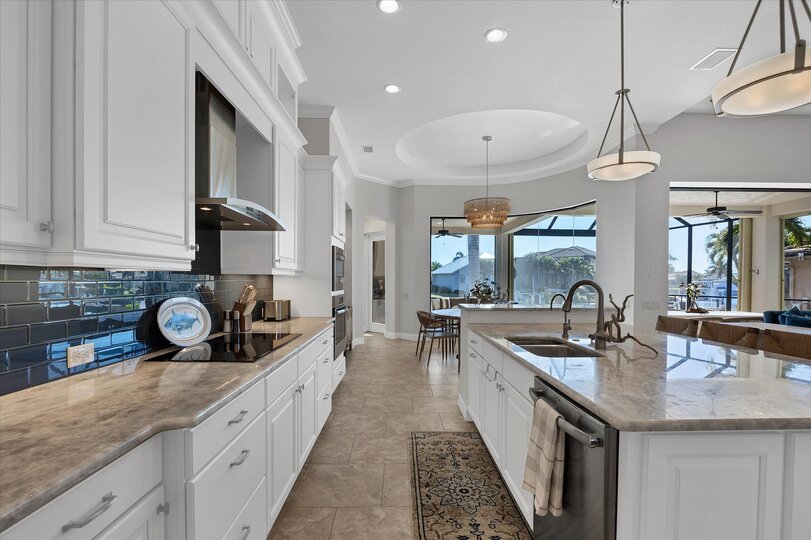 Gorgeous, fully-equipped kitchen over looking the living room and dining areas. Kitchen features lots of countertop & storage space, and stainless-steel appliances. Kitchen island seats 4