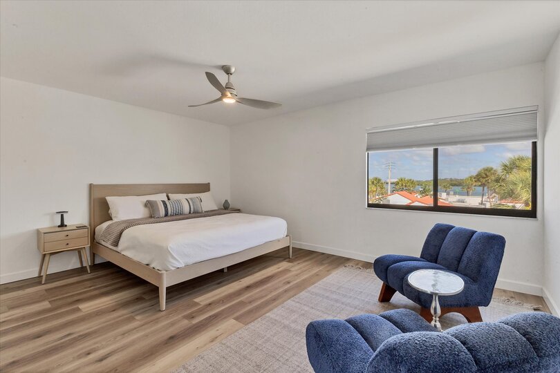 King bedroom with attached bathroom and view of bay