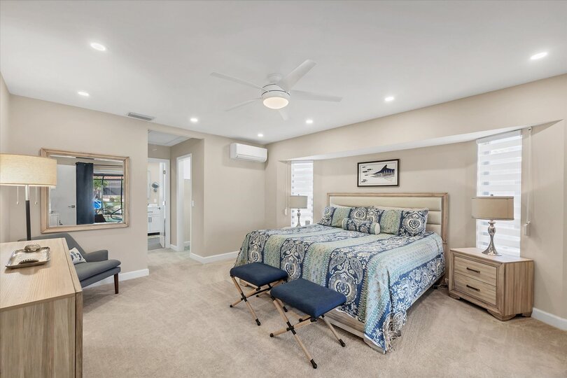 Primary Bedroom with King Bed, Attached Bathroom, and 55" Smart TV