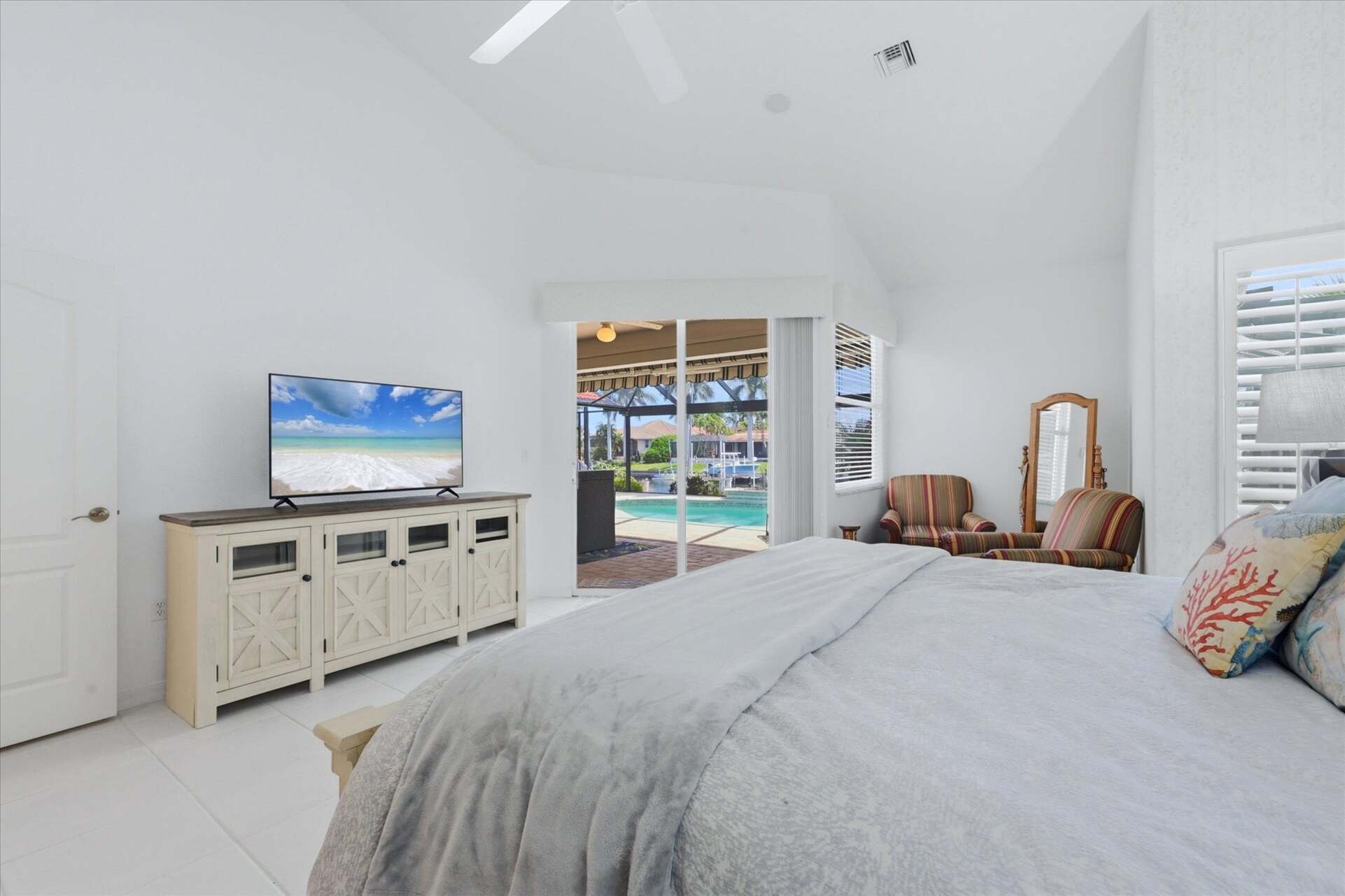 Primary bedroom with king bed, attached bathroom, lanai access, and 50-inch Smart TV